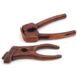 Two interesting pairs of antique treen nutcrackers, one with sprung action, the other of hinged