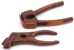 Two interesting pairs of antique treen nutcrackers, one with sprung action, the other of hinged