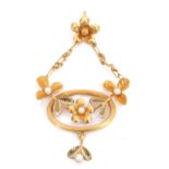 Edwardian period high grade yellow metal oval pendant with applied seed pearl mounted leaves and