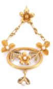 Edwardian period high grade yellow metal oval pendant with applied seed pearl mounted leaves and