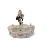 19th century Meissen style inkwell and pen tray with a cupid in disguise figure modelled as an