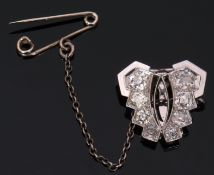 Precious metal diamond set clip, a butterfly design with four graduated old cut diamonds either side