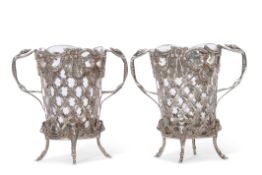 Unusual pair of glass lined Dutch 19th century silver vases with cast and pierced decoration and