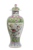 Chinese late 19th century vase and cover, the green ground with polychrome decoration of flowers