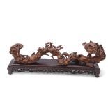 Chinese root carving on black wooden mount, 48cm long