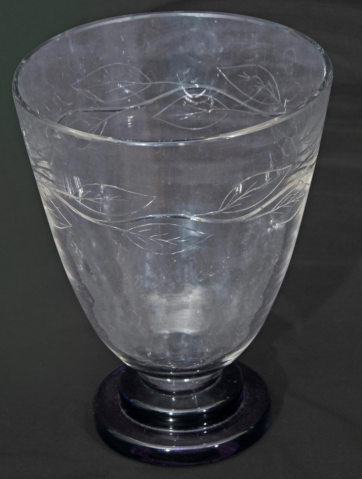 Art Deco glass vase of flared form on stepped purple base, decorated with stylised leaves in relief,