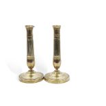 Pair of Regency period engraved brass candlesticks with circular bases, baluster and fluted columns,