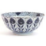 A Chinese porcelain bowl, Kangxi, the fluted body decorated with alternating flowerheads in Ming