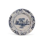 Mid-18th century Bristol Delft charger decorated with a chinoiserie design of a figure against a