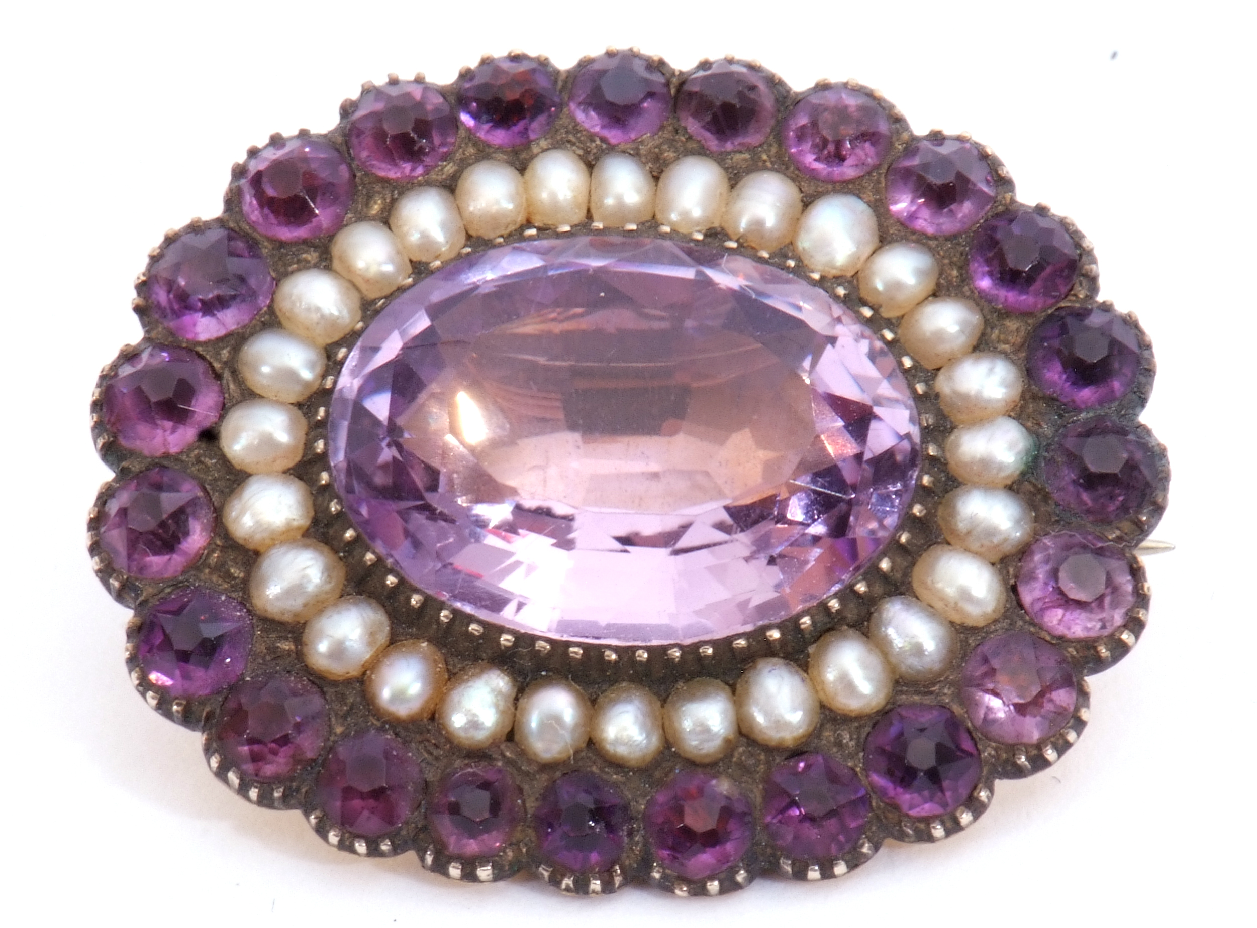 Victorian amethyst and seed pearl brooch, the large oval faceted amethyst 17mm x 12mm, within a seed - Image 4 of 5