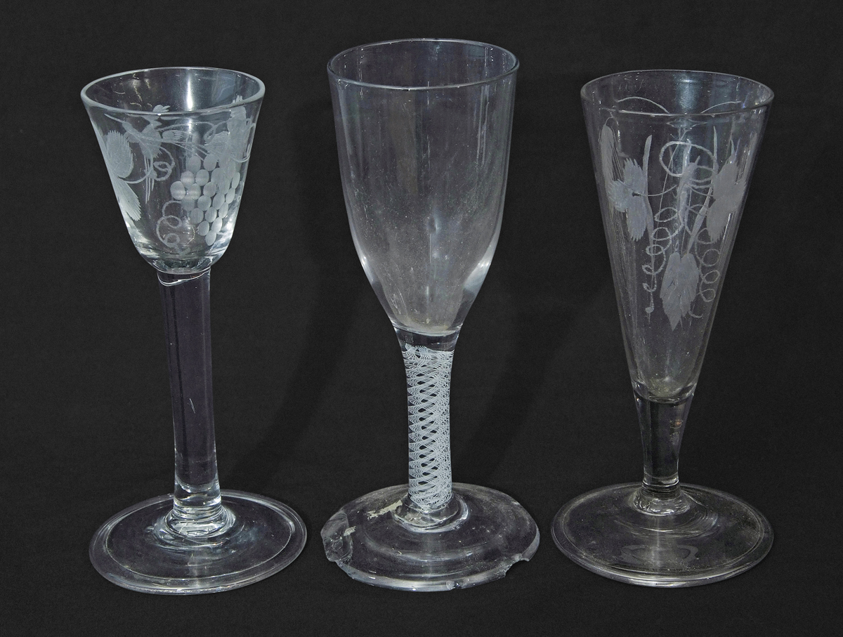 Fluted glass with engraved leaf decoration, a further air twist and a wine glass with grape