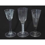 Fluted glass with engraved leaf decoration, a further air twist and a wine glass with grape