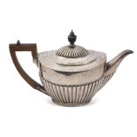 Victorian tea pot of three-quarter fluted oval form, treen finial and angular handle, Sheffield 1889