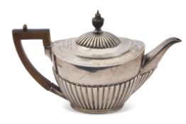 Victorian tea pot of three-quarter fluted oval form, treen finial and angular handle, Sheffield 1889