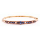 Sapphire and diamond hinged bracelet, the raised pierced gallery set with 13 round faceted sapphires