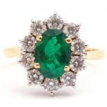 Emerald and diamond cluster ring, the oval faceted cut emerald 1.14ct approx, set within a