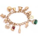 9ct gold curb link bracelet suspending various 9ct gold charms to include a football, a fireman's