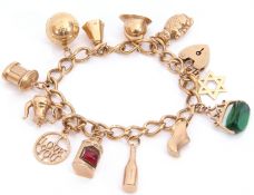 9ct gold curb link bracelet suspending various 9ct gold charms to include a football, a fireman's