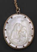 Early 19th century carved mother of pearl devotional pendant and chain, the oval shaped mother of