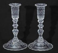 Pair of glass candlesticks, 19th century, with knopped faceted stems on a domed base, 23cm high