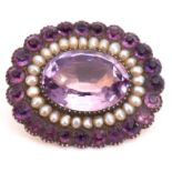 Victorian amethyst and seed pearl brooch, the large oval faceted amethyst 17mm x 12mm, within a seed