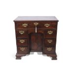 Mahogany small desk, full width frieze drawer over kneehole with cupboard and two integral