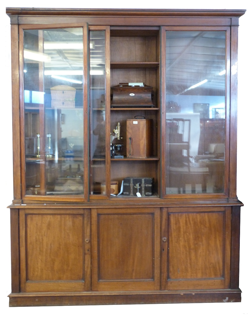 19th century mahogany library bookcase, by W H Travers, the glazed top with fitted adjustable