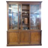 19th century mahogany library bookcase, by W H Travers, the glazed top with fitted adjustable