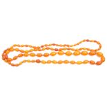 Butterscotch amber bead necklace, a single row of oval shaped beads, 27mm to 7mm, g/w 65.4gms