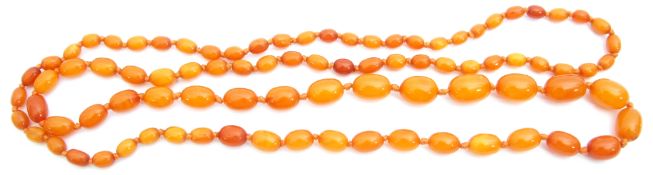 Butterscotch amber bead necklace, a single row of oval shaped beads, 27mm to 7mm, g/w 65.4gms