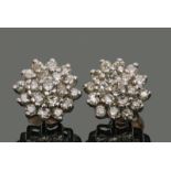 Pair of diamond cluster earrings, each featuring 19 small single cut diamonds in a flowerhead