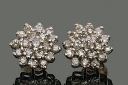 Pair of diamond cluster earrings, each featuring 19 small single cut diamonds in a flowerhead