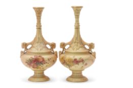 Pair of Royal Worcester blush ground vases with slender necks and rams head handles, the blush
