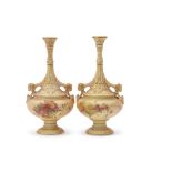 Pair of Royal Worcester blush ground vases with slender necks and rams head handles, the blush