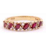 An 18ct gold, ruby and diamond ring, alternate set with angled lozenge shaped rubies and pairs of