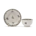 Lowestoft porcelain tea bowl and saucer decorated with a sepia design of floral sprays with diaper