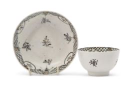 Lowestoft porcelain tea bowl and saucer decorated with a sepia design of floral sprays with diaper