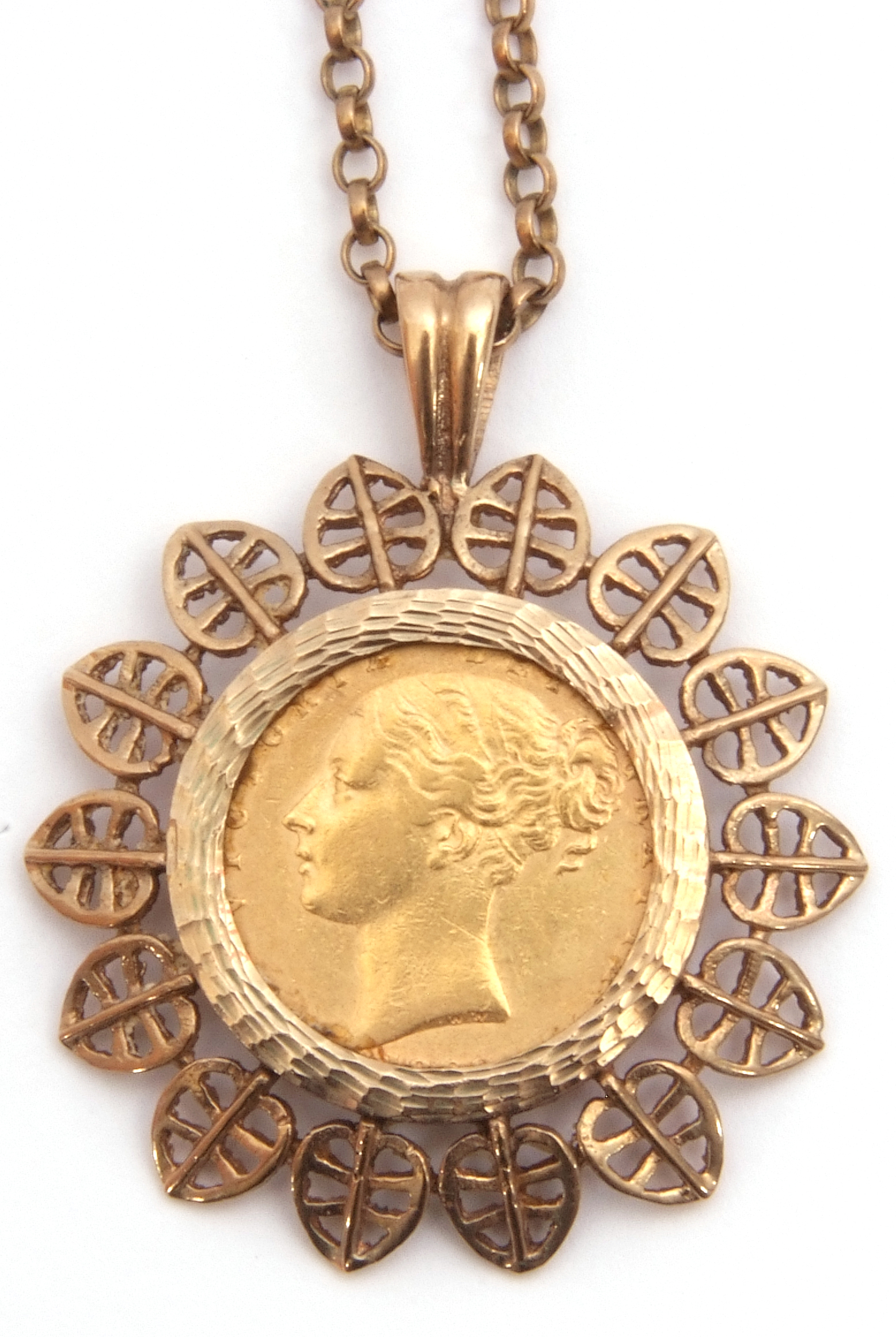 Victorian gold shield back sovereign within a hallmarked 9ct gold filigree leaf edge design pendant,