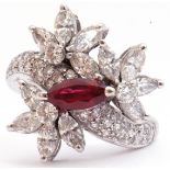 Precious metal, ruby and diamond cluster cocktail ring, centring a marquis shaped ruby raised