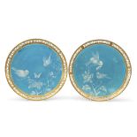 Pair of 19th century Minton plates with enamel decoration of birds on a turquoise ground within