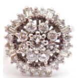 18ct white gold and diamond cluster ring, the pierced panel with a brilliant cut diamond flower head