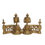 Pair of 19th century gilded andirons, crested with swag and urn capitals and the bases applied