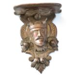 Unusual oak wall bracket, the support carved in the form of a Royal head encrusted with nuts and