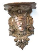 Unusual oak wall bracket, the support carved in the form of a Royal head encrusted with nuts and