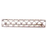 Diamond set brooch of elongated rectangular pierced form with a lattice work design, highlighted