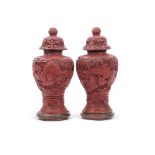 Pair of cinnabar style vases and covers, 24cm high