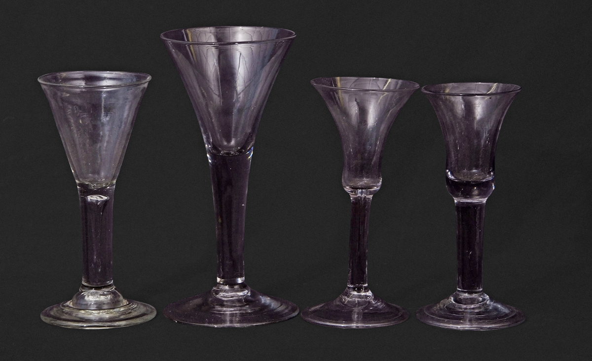 Four 18th century glasses including two with bell shaped bowls, one with funnel bowl and a small