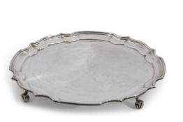 Cased Elizabeth II salver of circular form with "Chippendale" rim, plain centre and raised on four