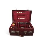 Edwardian red morocco leather travelling case with some original fittings including four silver
