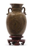 An unusual Chinese pottery vase with an agate or faux wooden effect glaze on wooden stand, 13cm